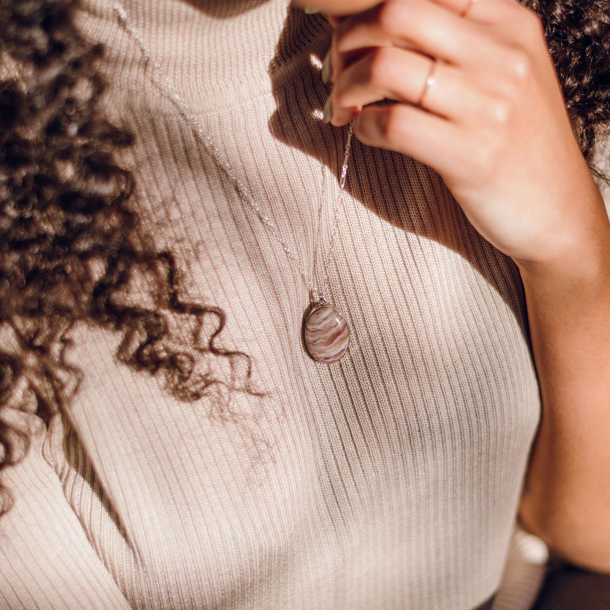 A natural stone pendant necklace set in sterling silver