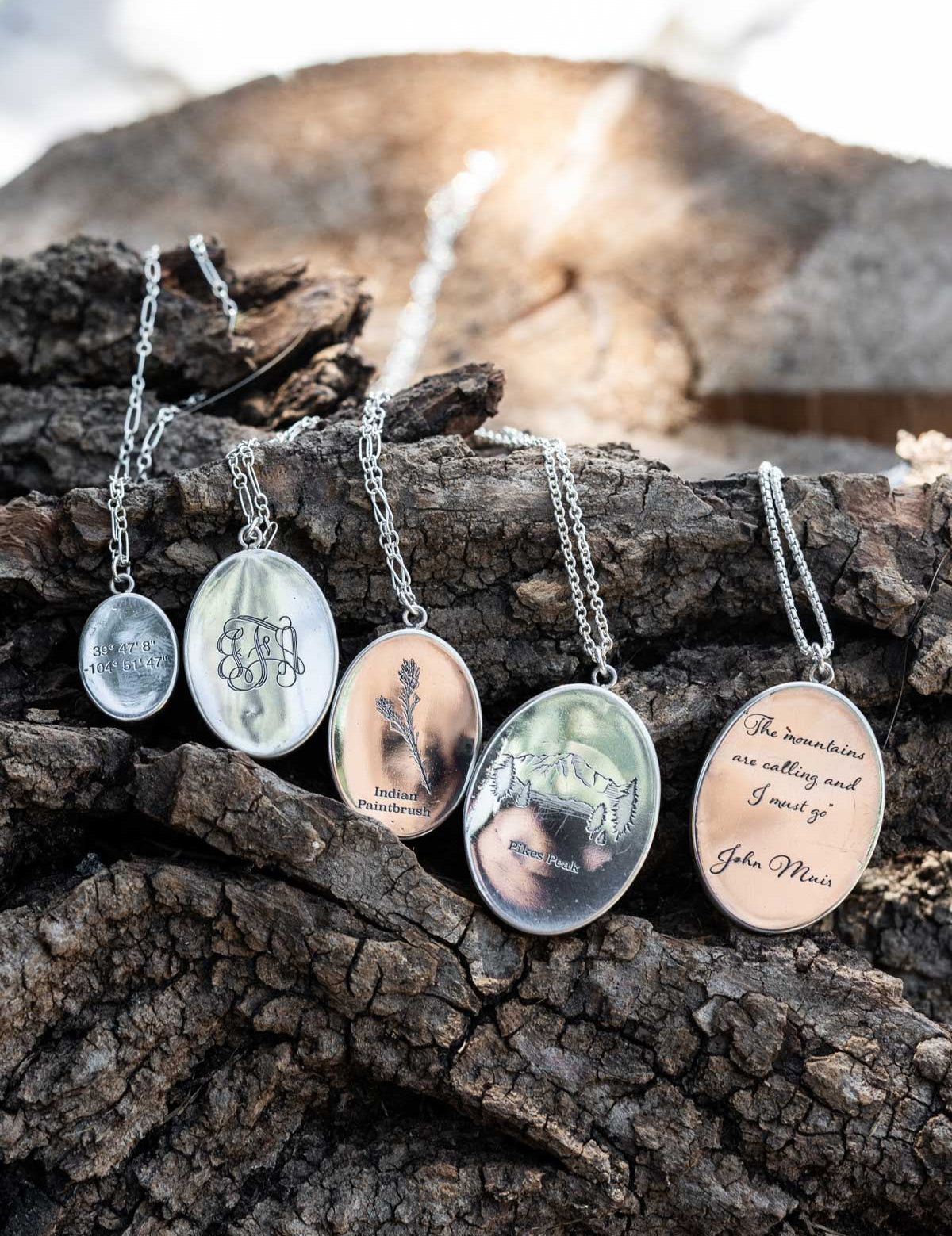 A row of pendant necklaces with different custom engraving options