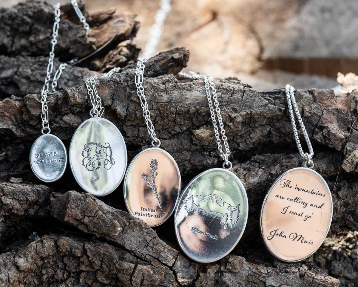 A row of pendant necklaces with different custom engraving options