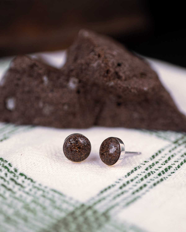 Silver stud earrings made with a reddish-brown natural stone