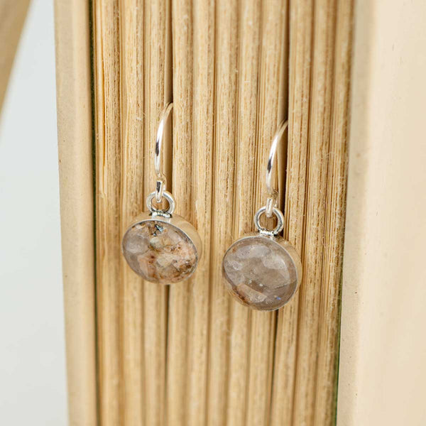 Sterling silver dangle earrings set with natural round brown stones