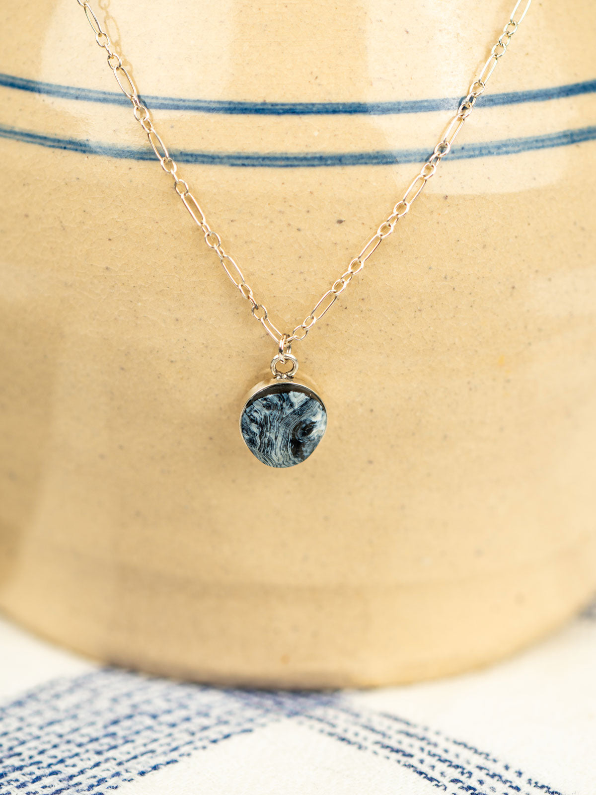 Sterling silver necklace with a striped agate stone pendant