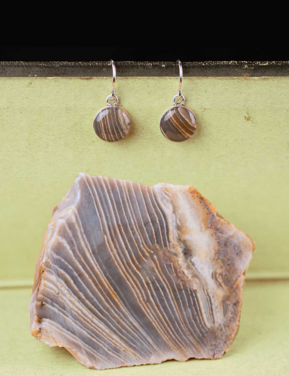 Pair of stone dangle earrings set in sterling silver with the rock they were made from