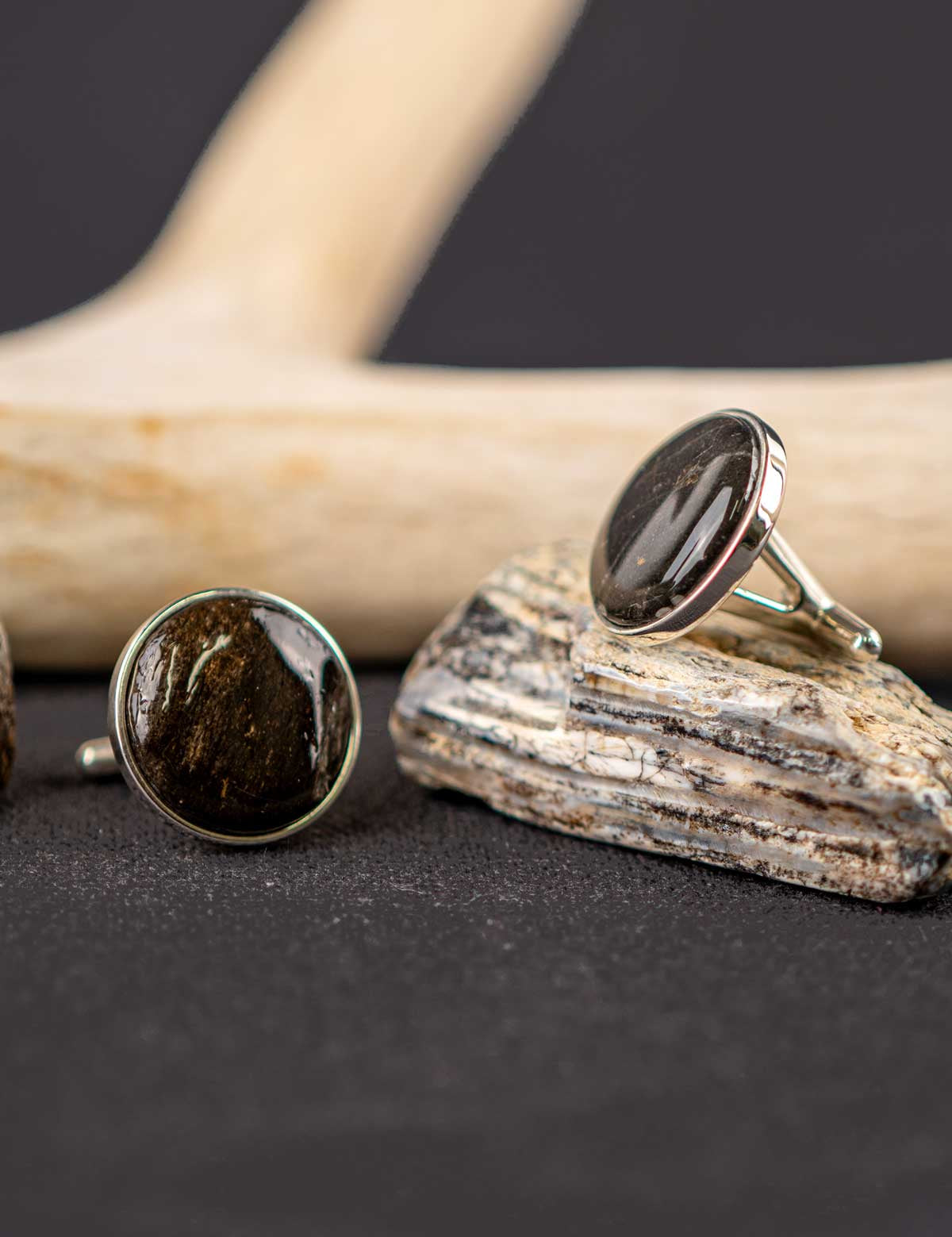 Pair of silver cufflinks made from a fossilized tooth