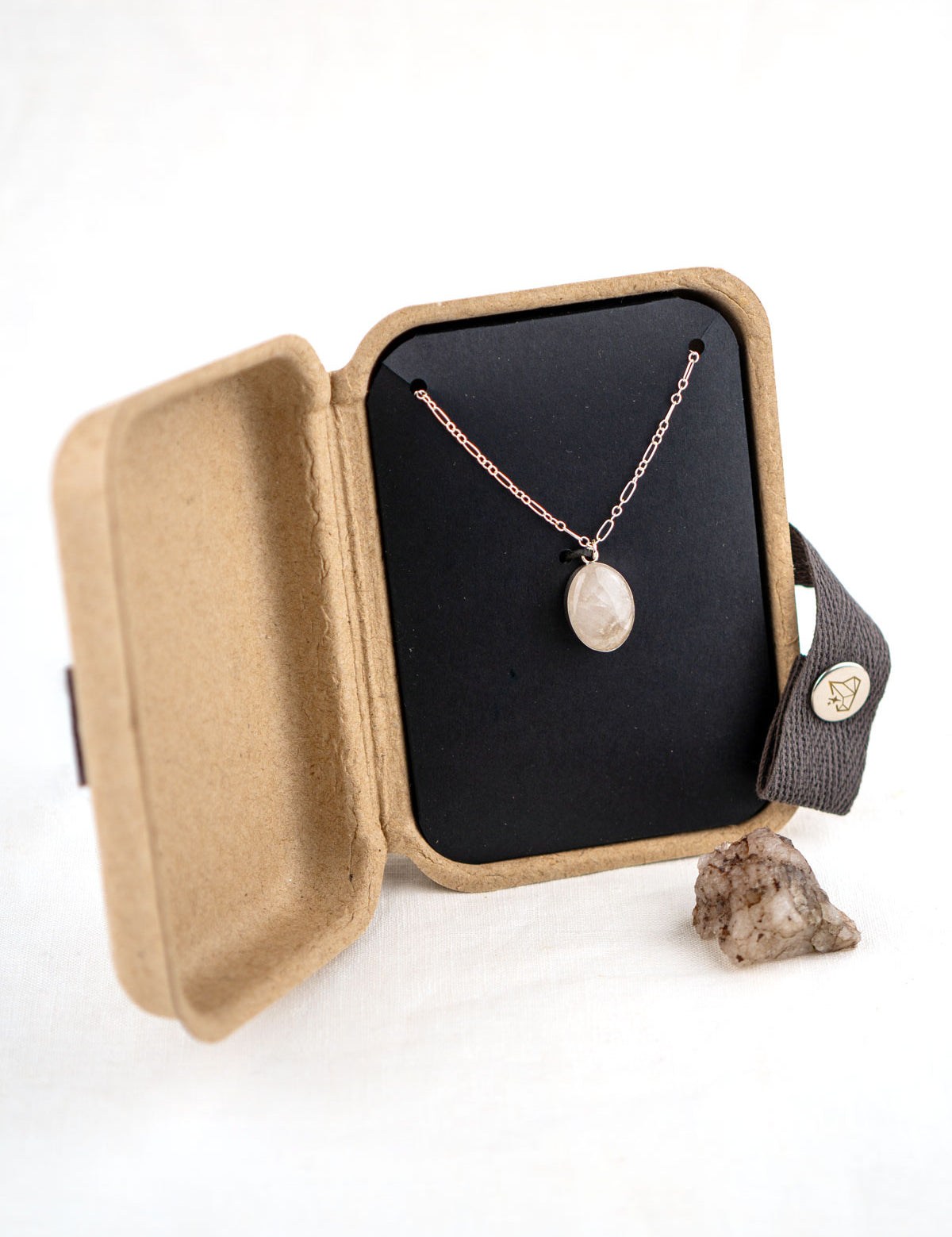 Sterling silver necklace with a small stone pendant in a kraft jewelry box with the original rock the necklace was made from