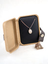 Sterling silver necklace with a small stone pendant in a kraft jewelry box with the original rock the necklace was made from