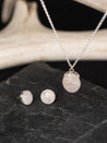 Sterling silver matching jewelry set, including round stud earrings and an ovel pendant, made with white quartz 