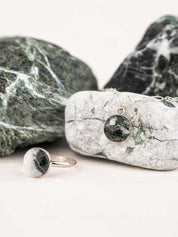 A round stone ring and a matching necklace made from the same greenish white rock and set in sterling silver