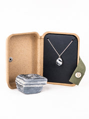 Striped stone pendant necklace made from a natural rock in an open gift box made from plastic free materials