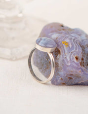 Silver ring with a natural round stone and the purple stone it was made from