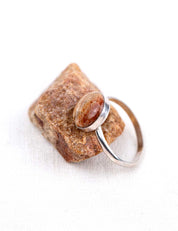 Round sterling silver ring with the natural reddish brown stone it was made from