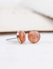 Pair of pink stone stud earrings with a gold setting custom engraved on the edge