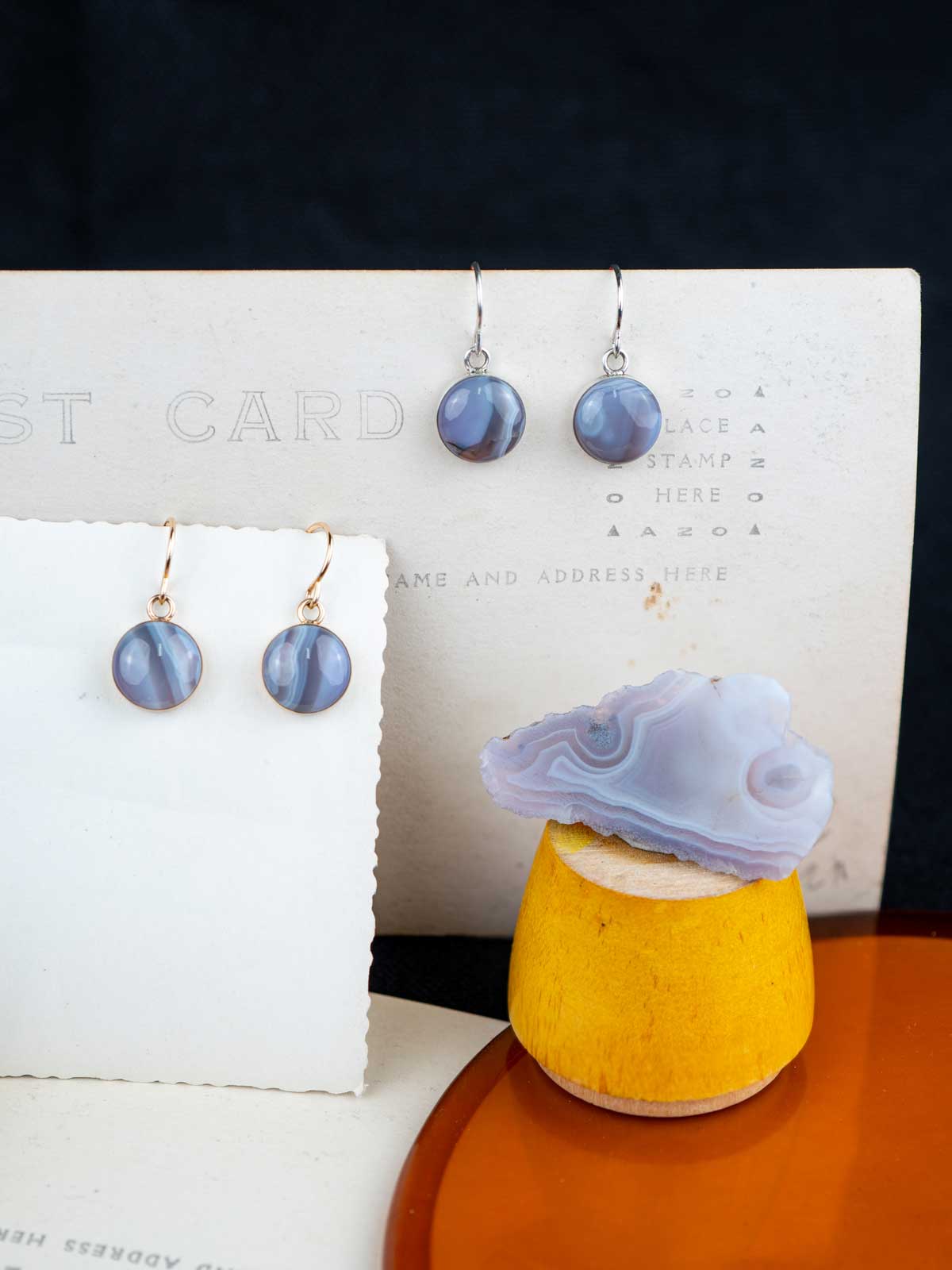 Holly blue agate dangle earrings displayed with the original stone they were made from