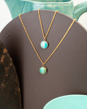 Two gold pendants set with Amazonite show the unique differences between stones