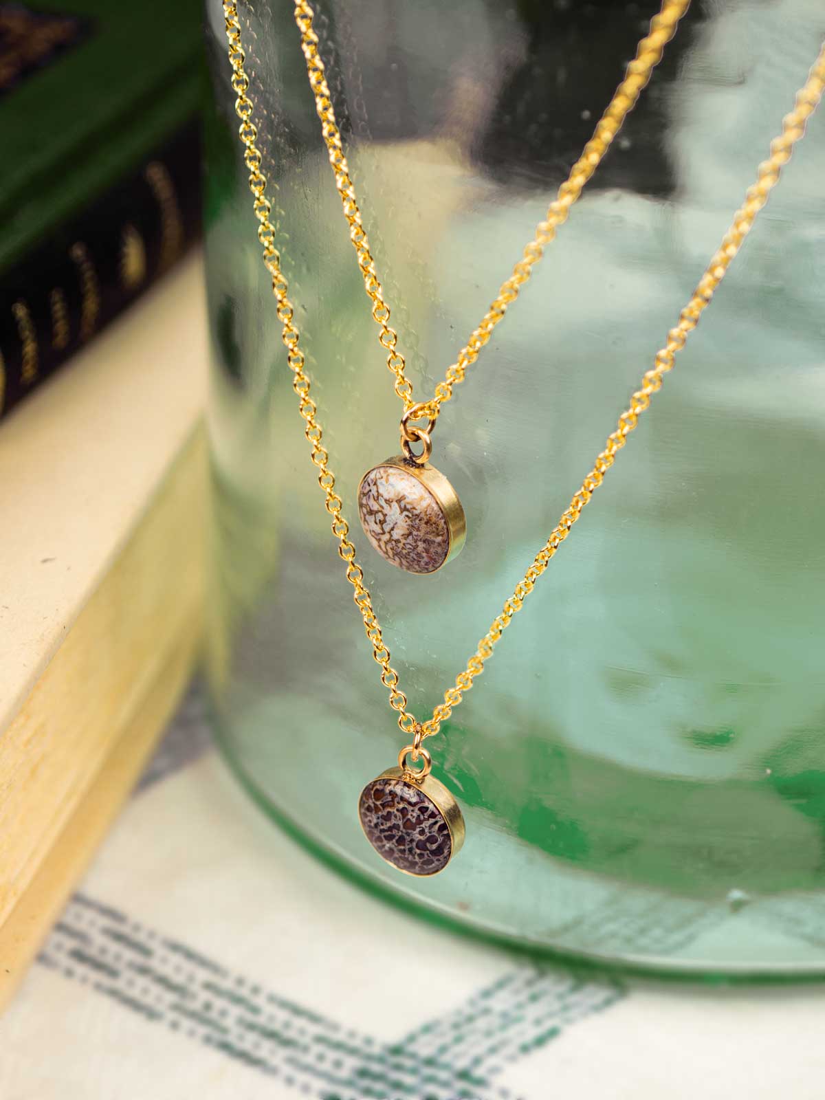 Two fossillized dinosaur bone necklaces made from 14k gold fill chain