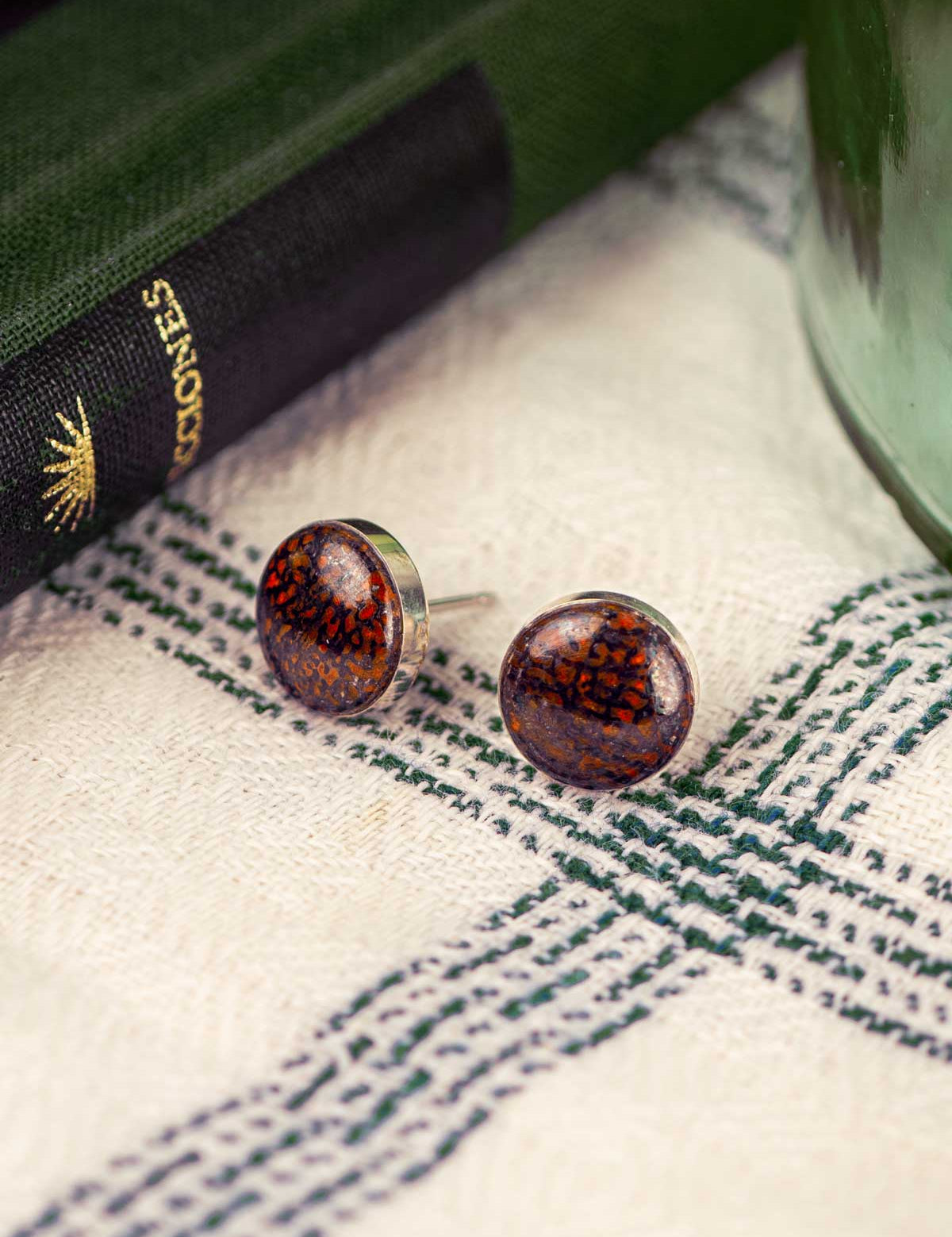 Red fossilized dinosaur bone round stud earrings