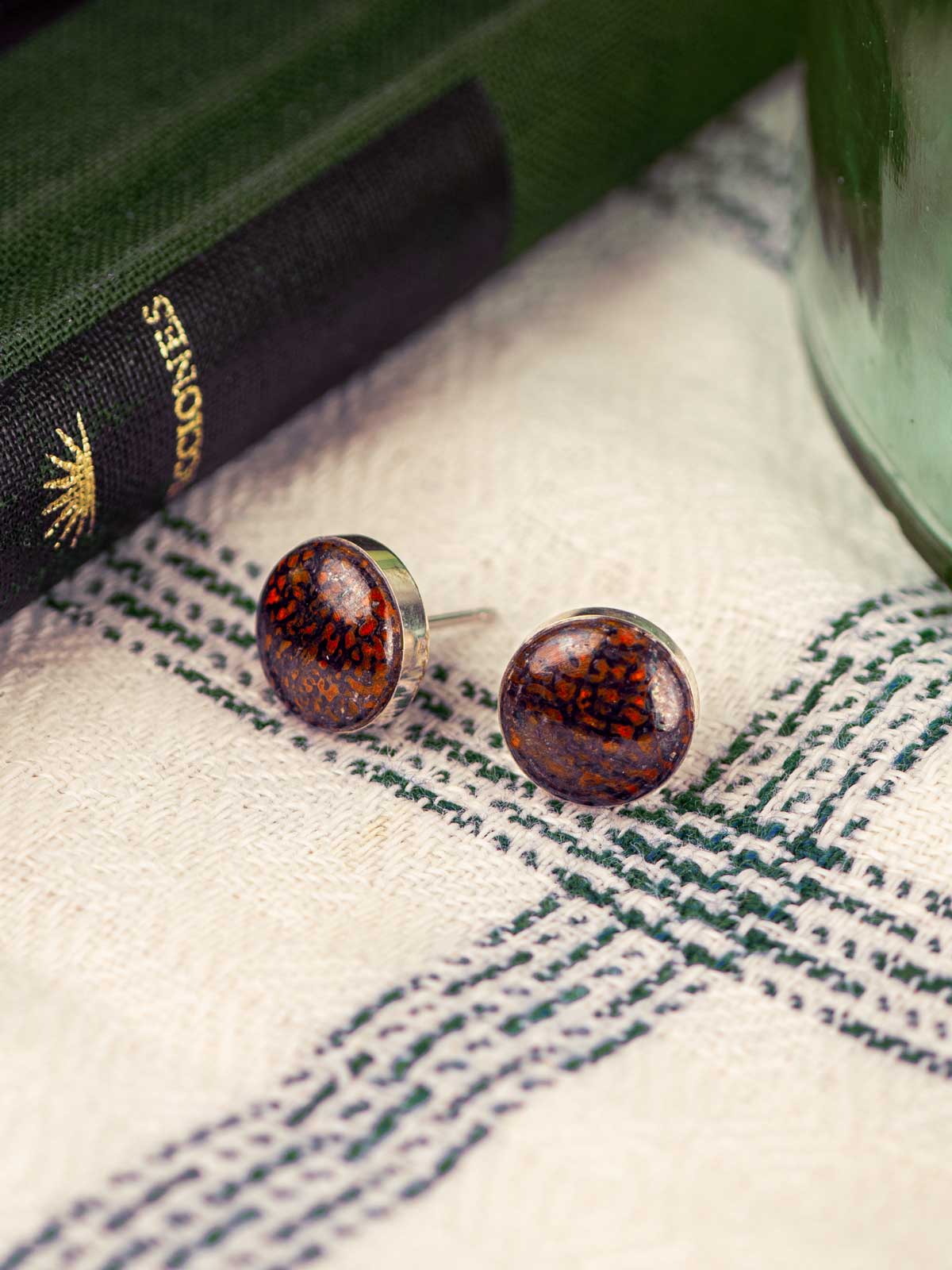 Red fossilized dinosaur bone round stud earrings
