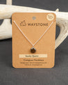 Waystone smoky quartz compass necklace on a brown card with deer antlers in the background