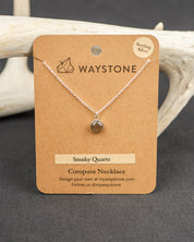 Waystone Smoky Quartz Compass Necklace on a brown kraft card with deer antlers in the background
