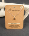 Waystone Smoky Quartz Compass Necklace on a brown kraft card with deer antlers in the background