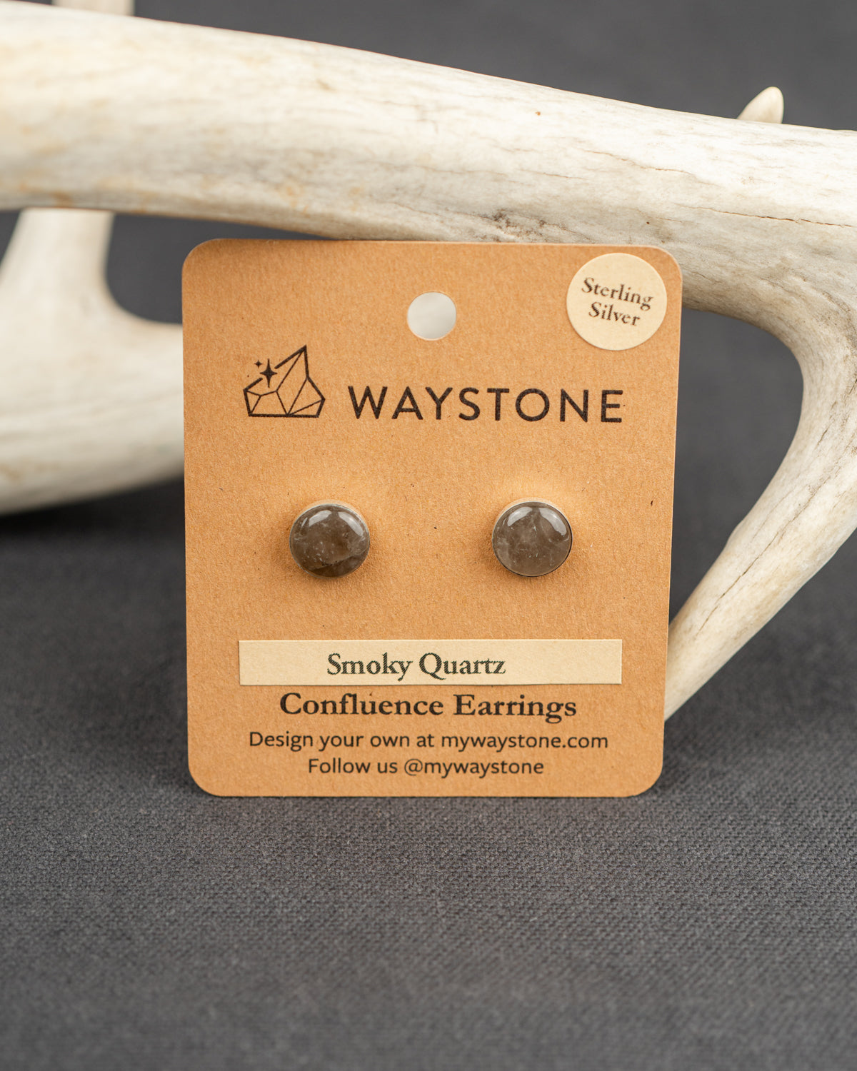 Smoky Quartz sterling silver stud earrings on a Waystone branded card with antlers in the background