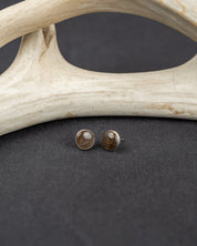 Pair of sterling silver round stud earrings set with gray smoky quartz