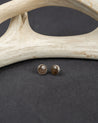 Pair of sterling silver round stud earrings set with gray smoky quartz