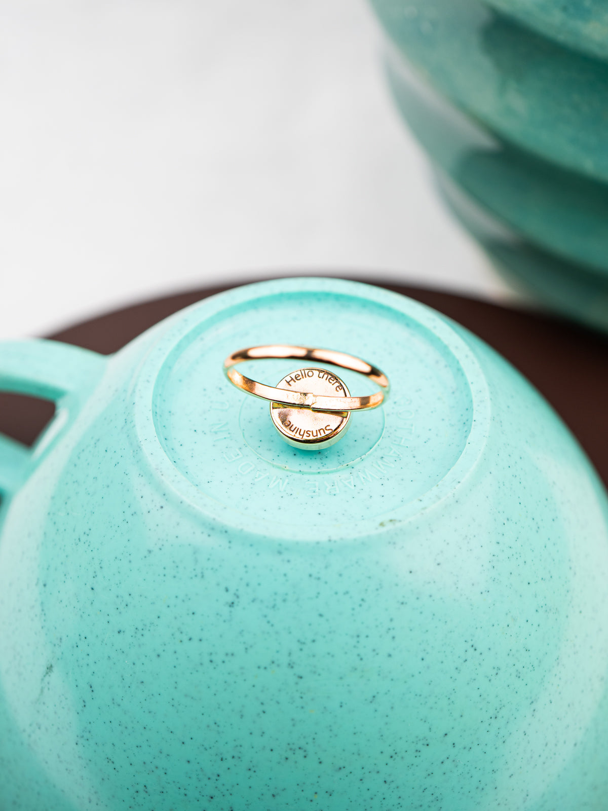 Gold fill ring set with a round stone custom engraved on the back of the setting