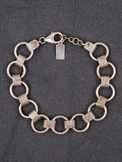 Sterling Silver hammered masculine bracelet on a gray fabric background
