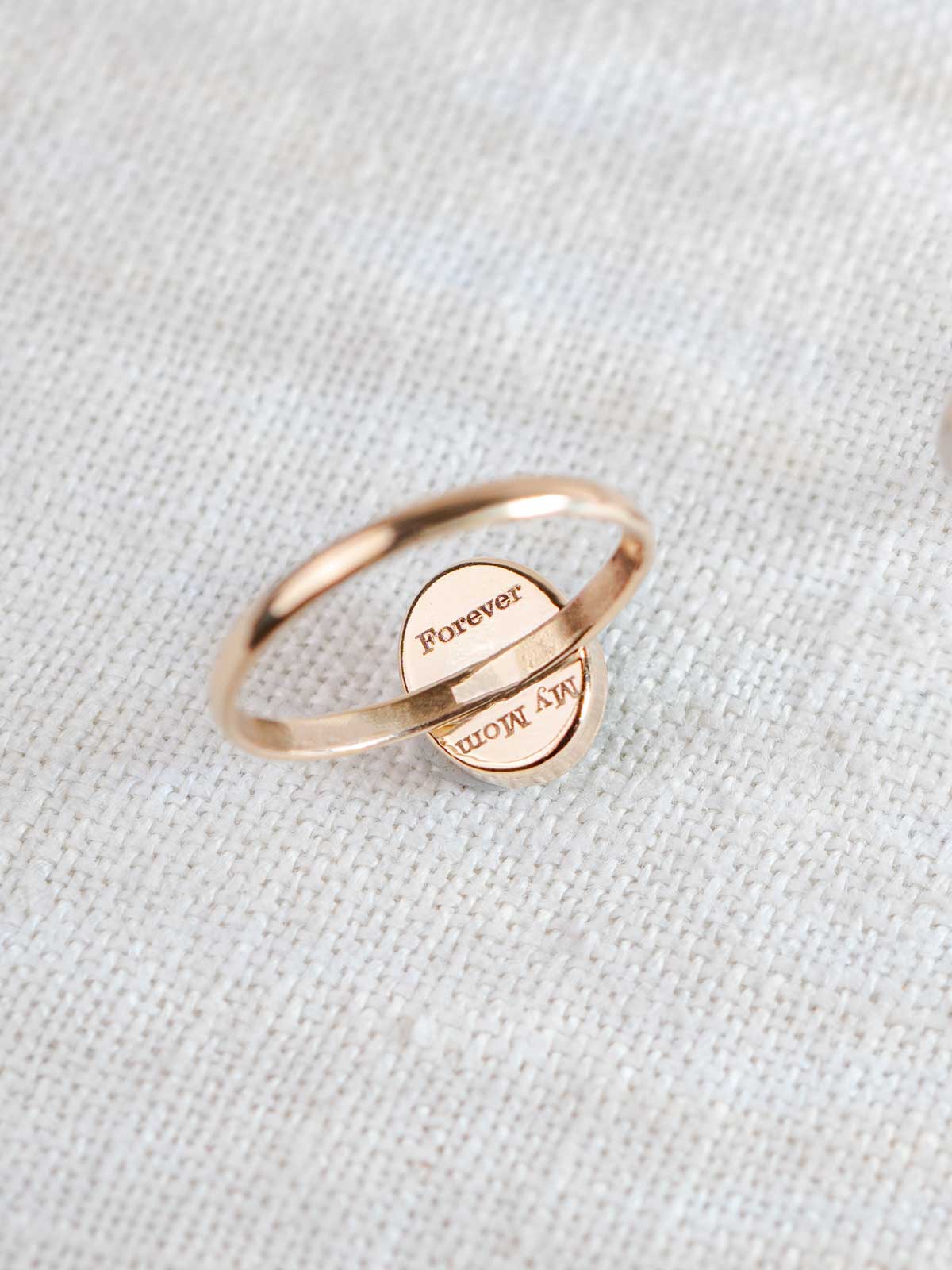 Gold fill ring with the engraved text "Forever My Mom" on the back of the oval stone setting