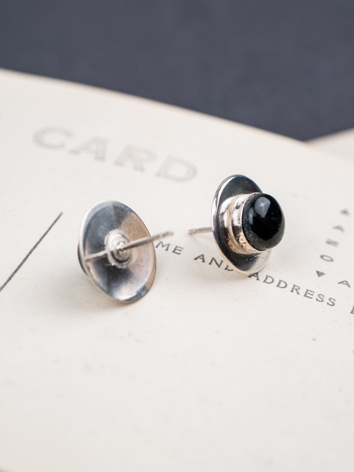 Pair of Sterling Silver Black Jade earrings on a post card