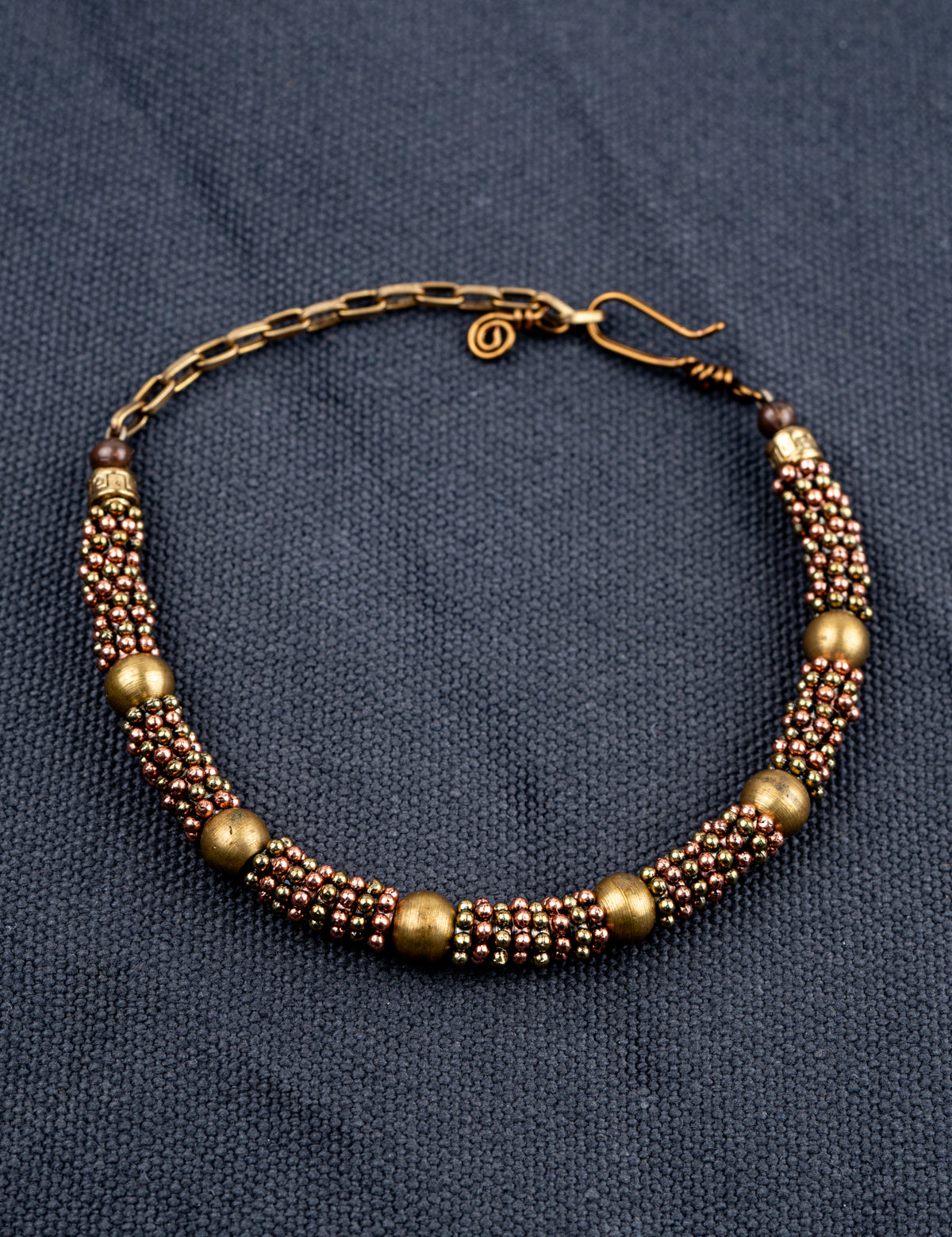 Sterling Silver chain bracelet on a gray fabric background