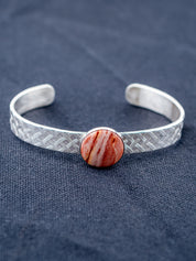 Sterling Silver bracelet on a gray fabric background