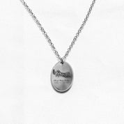 Oval silver charm necklace with an engraving of a wedding venue