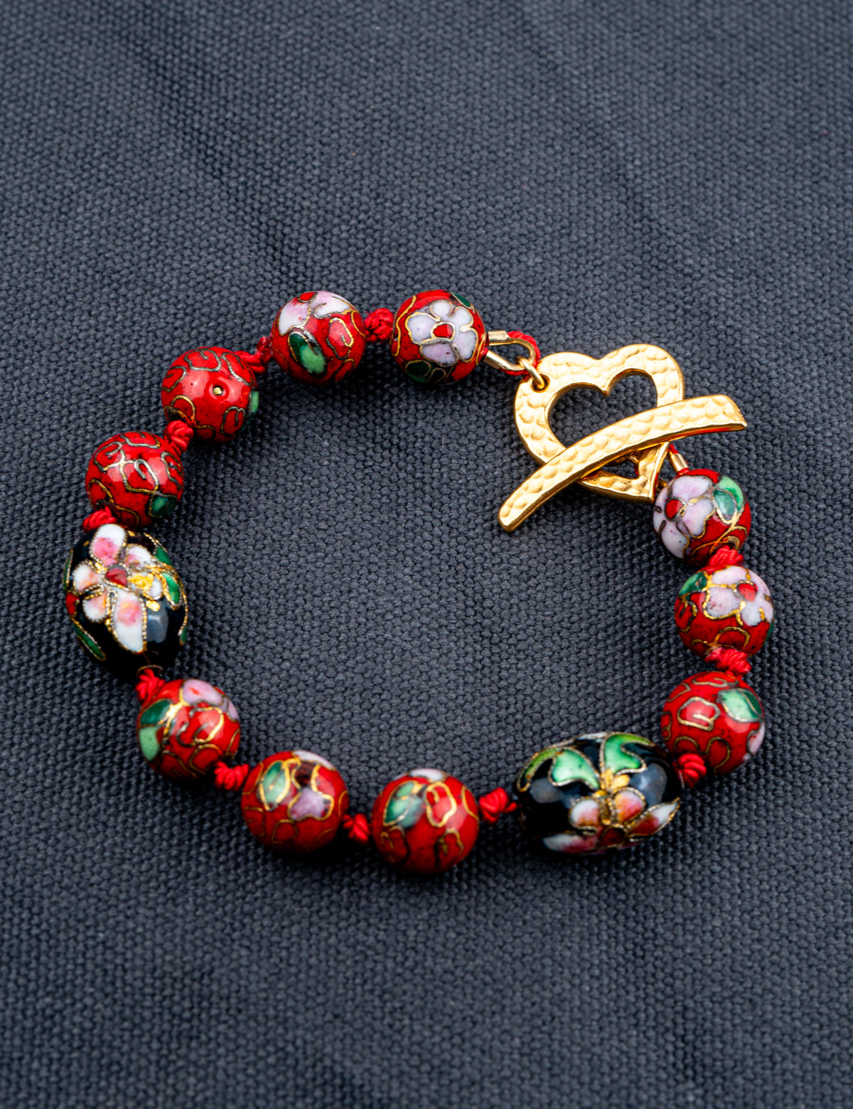 Cloisonne Silkcord bracelet on a gray fabric background