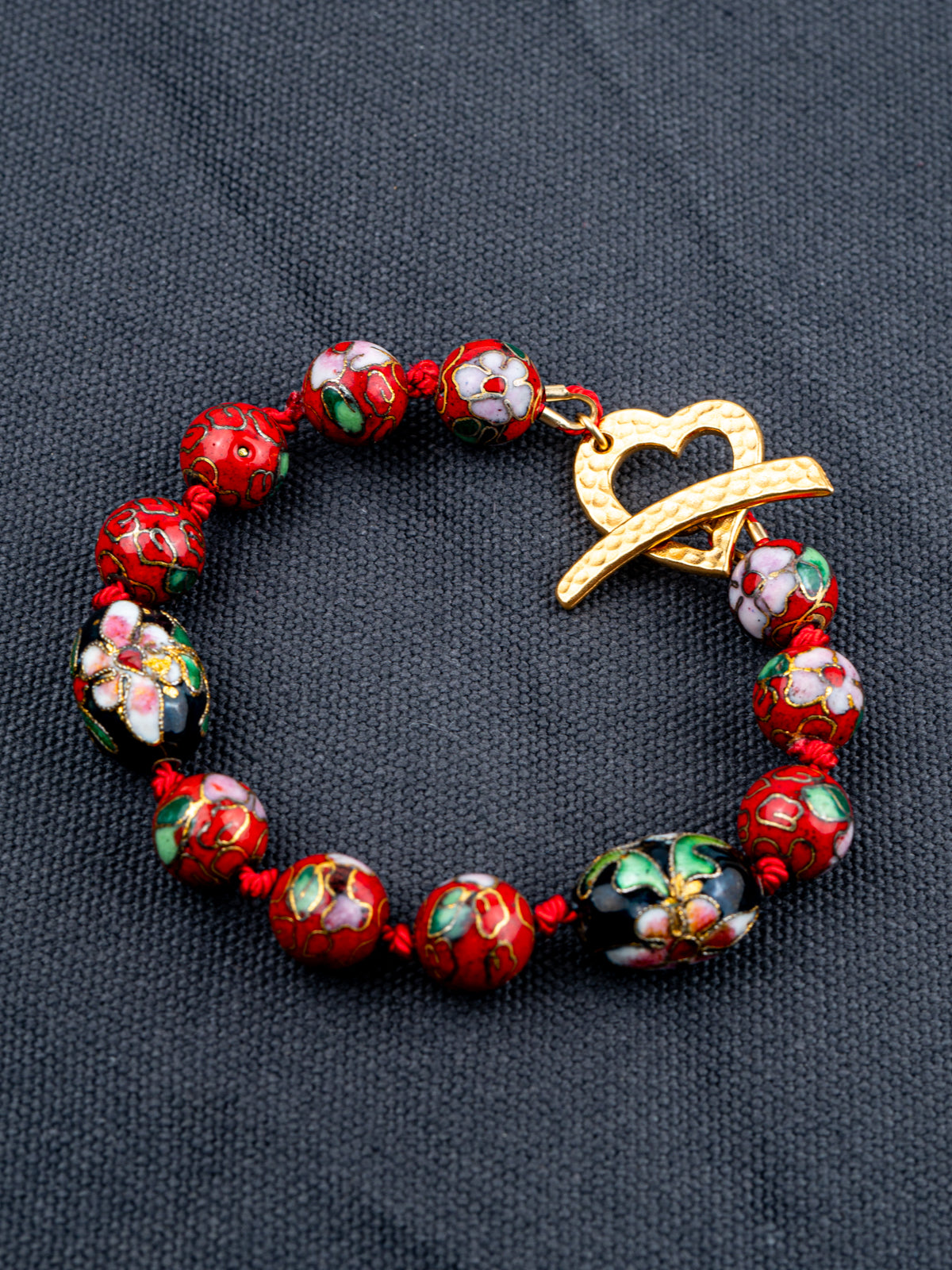 Cloisonne Silkcord bracelet on a gray fabric background