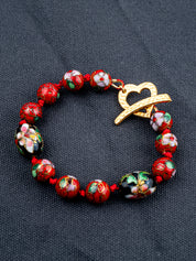 Cloisonne Silkcord bracelet on a gray fabric background
