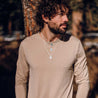 A man wears engraved silver chain necklaces with custom engraved charms