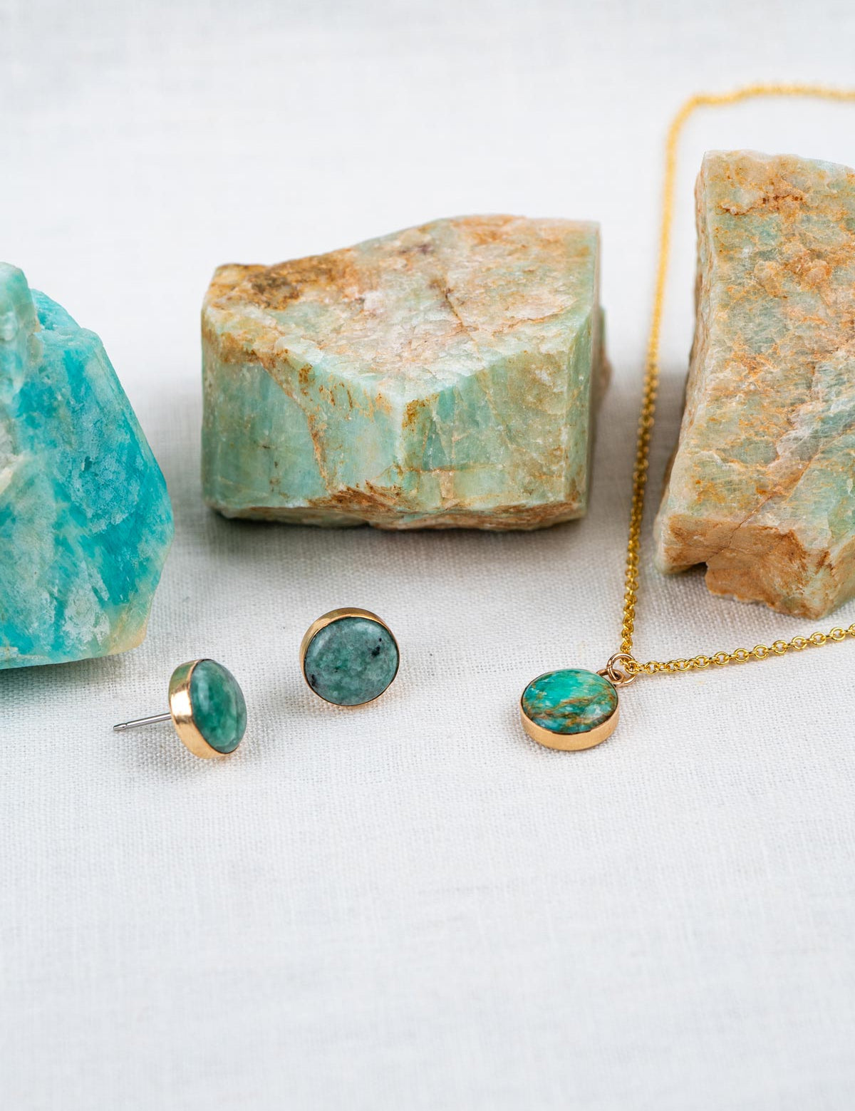 Jewelry set with natural stones that includes a small round pendant necklace and round stud earrings, all set in 14k gold fill