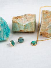 Jewelry set with natural stones that includes a small round pendant necklace and round stud earrings, all set in 14k gold fill