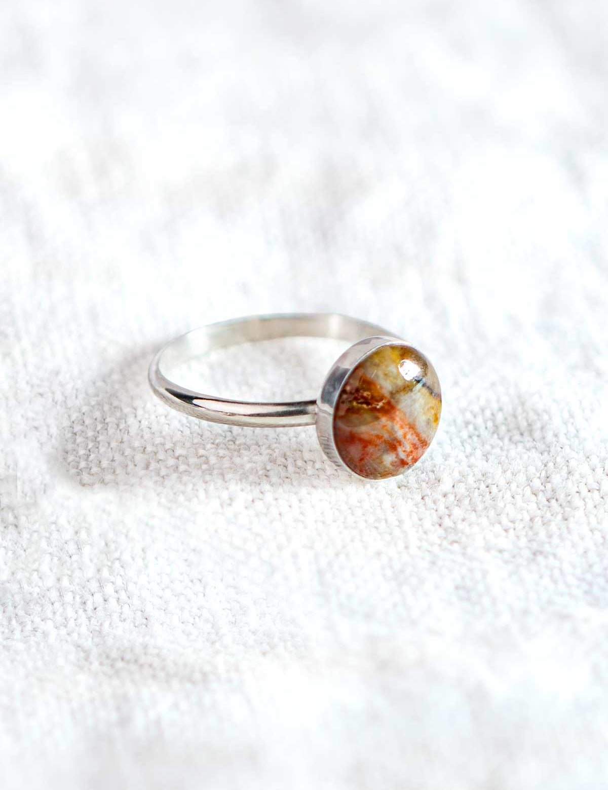 Silver ring set with a colorful round rock