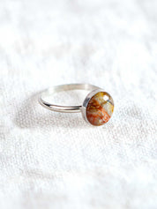 Silver ring set with a colorful round rock