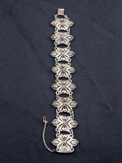 Sterling Silver chain bracelet on a gray fabric background