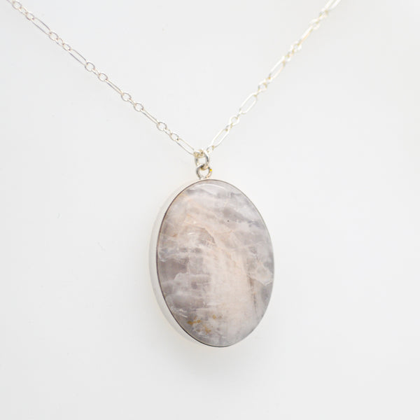 Natural white stone set as an oval pendant