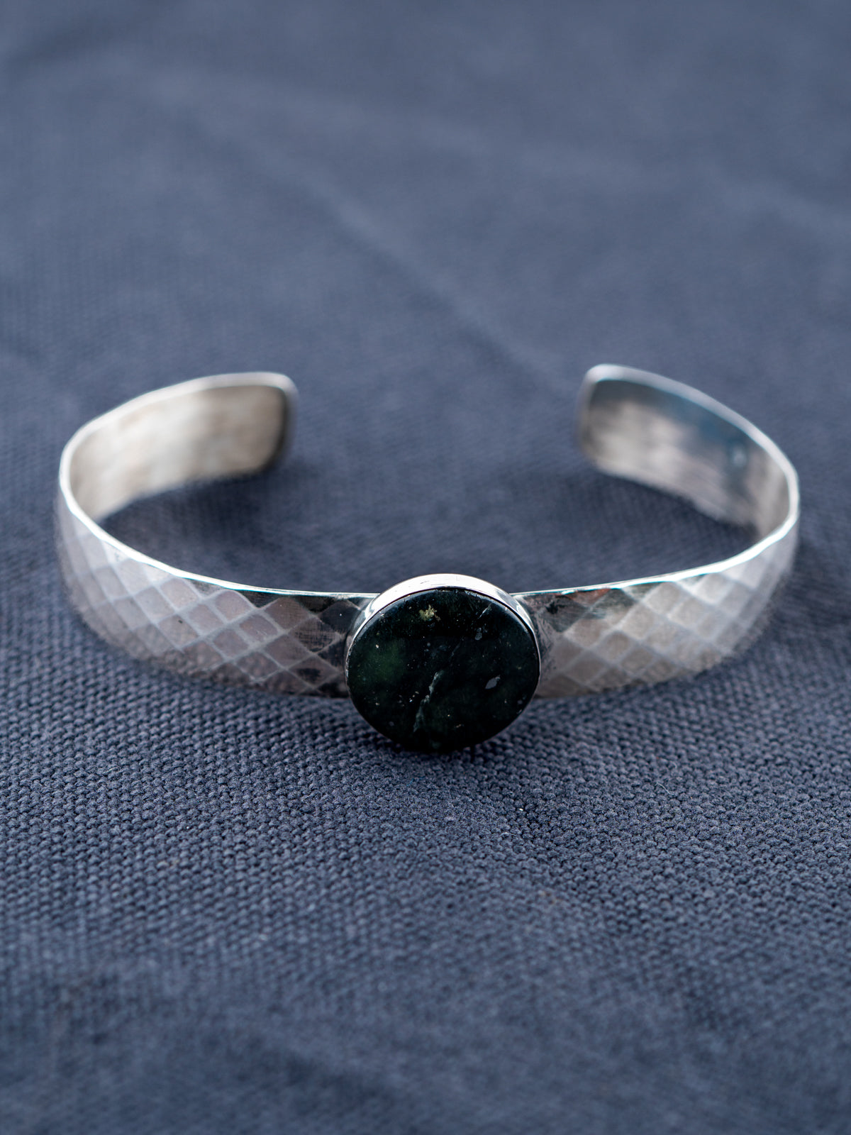 Sterling Silver bracelet on a gray fabric background