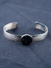 Sterling Silver bracelet on a gray fabric background