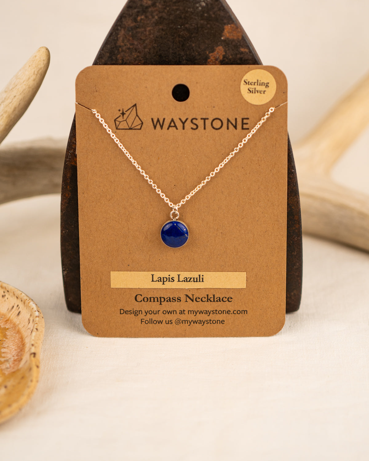 Lapis Lazuli compass necklace on a Waystone branded card 