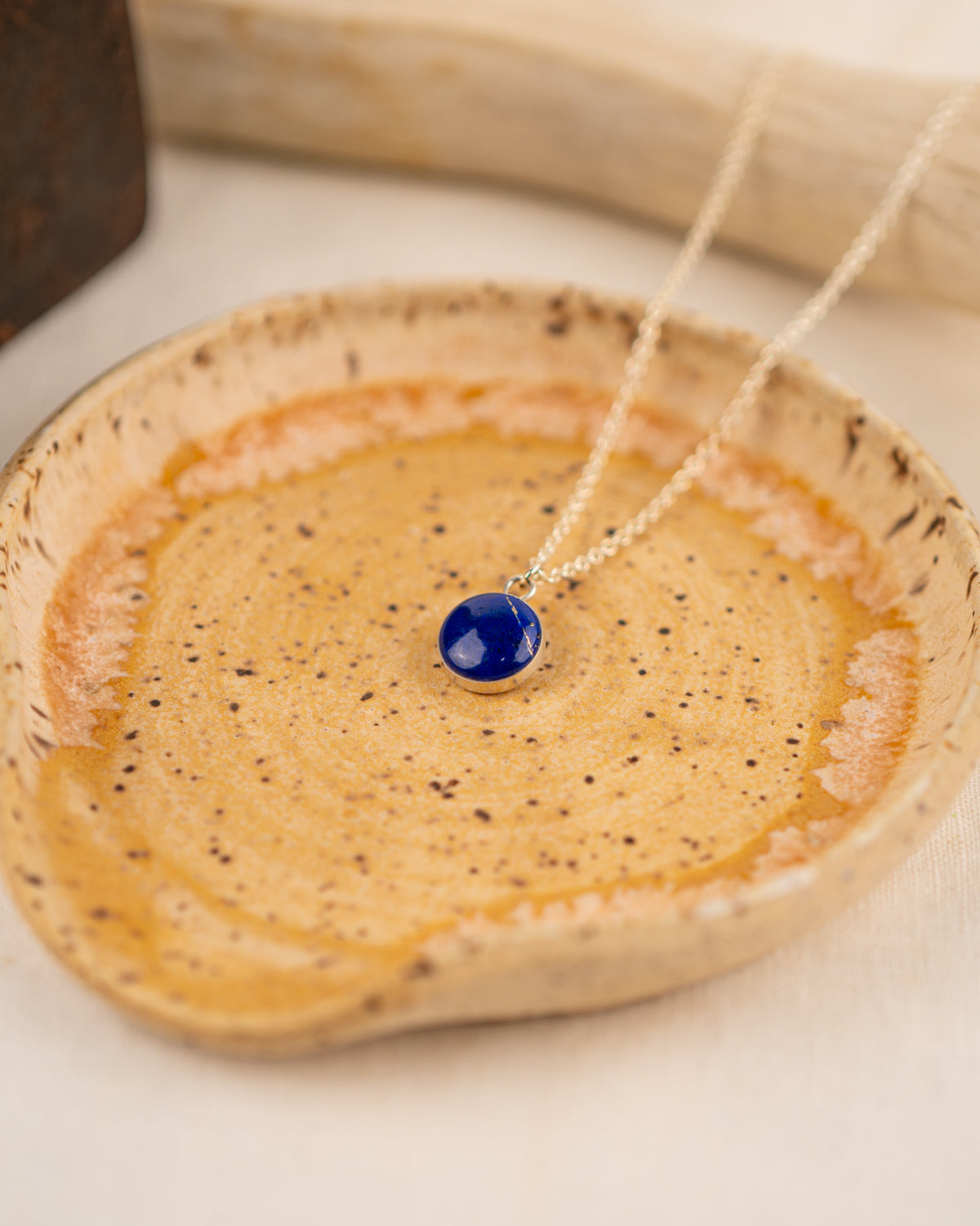 Necklace with a small round lapis lazuli pendant on a silver chain