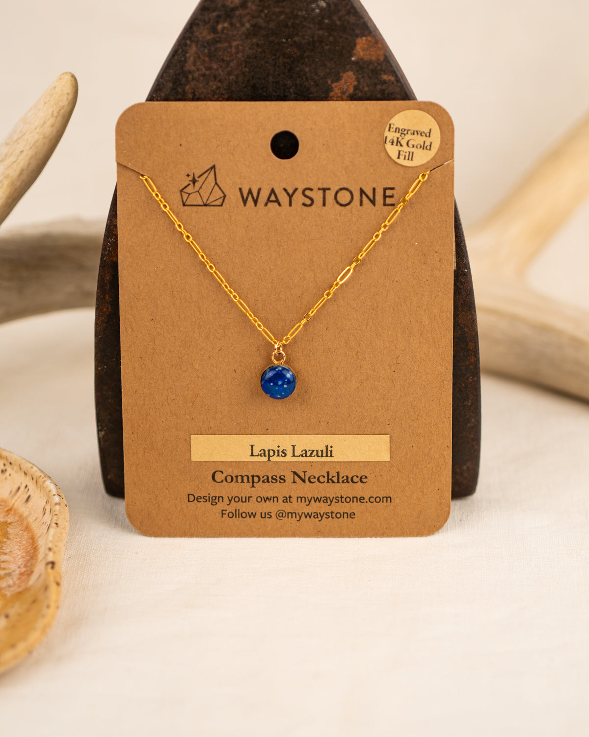Waystone Lapis Lazuli Compass Necklace on a brown card with gold chain