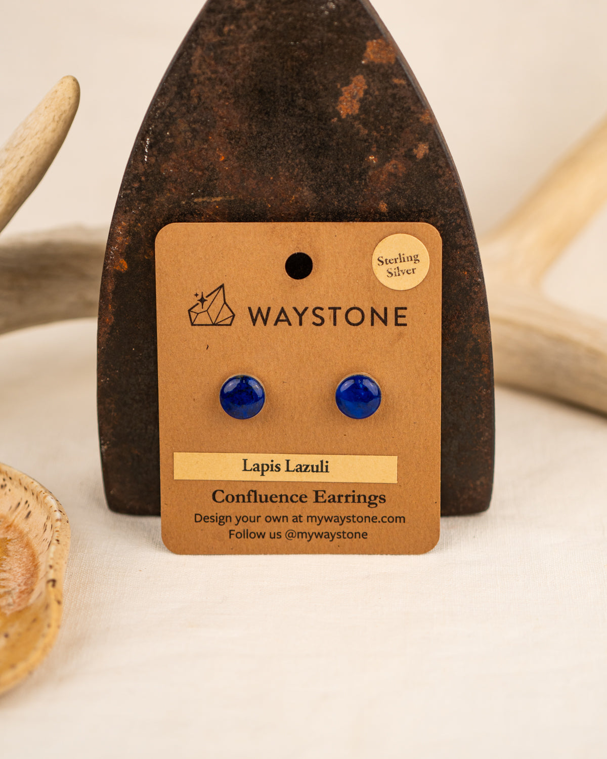 Bright blue lapis lazuli stud earrings on a Waystone branded card